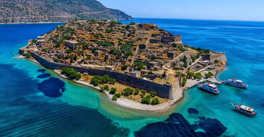 Crete: Spinalonga, Elounda, & Agios Nikolaos Boat Tour & BBQ - Elounda first: the calm shore base before the island jump