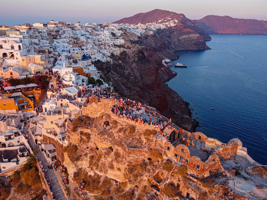 From Fira: Santorini Highlights Minibus Tour with Oia Sunset - Megalochori village on cobblestones: charm, color, and a time-management note