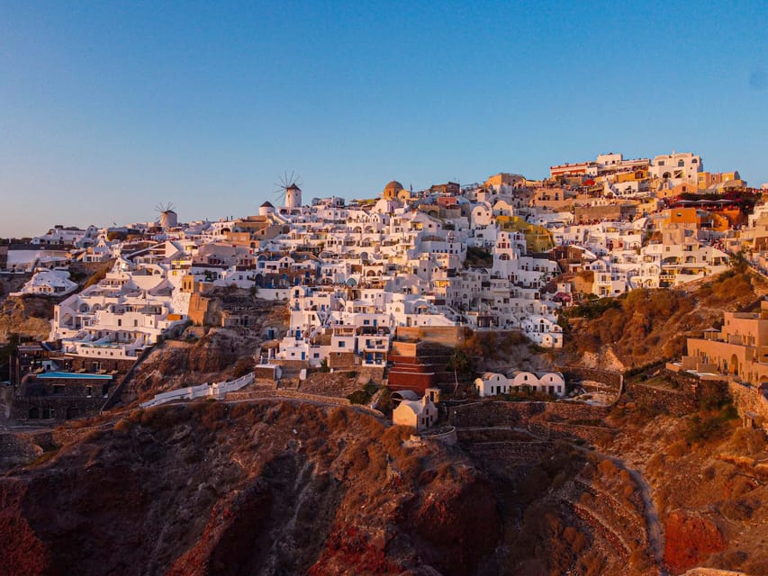 From Fira: Santorini Highlights Minibus Tour with Oia Sunset - Perissa Beach free time: black sand swimming and lunch on your terms