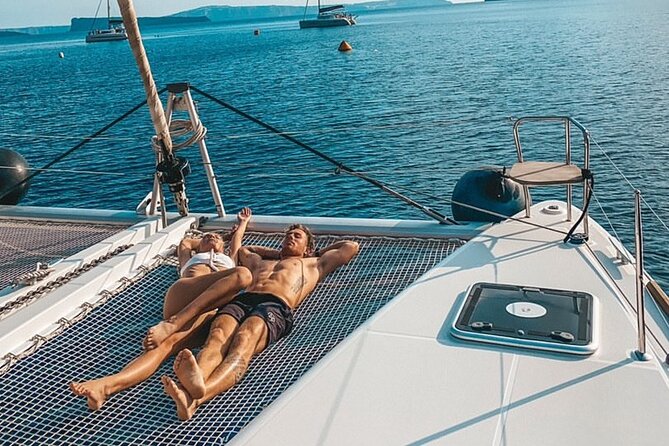 Half-Day Exclusive Catamaran Cruise in Santorini with Meal and Open Bar - The sailing part: White Beach, Venetian Lighthouse, and caldera coastline views