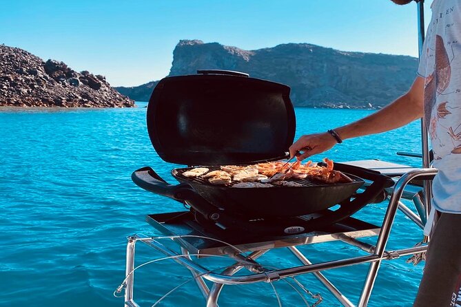 Half-Day Exclusive Catamaran Cruise in Santorini with Meal and Open Bar - Santorini volcano and hot springs: warm water, no big ceremony