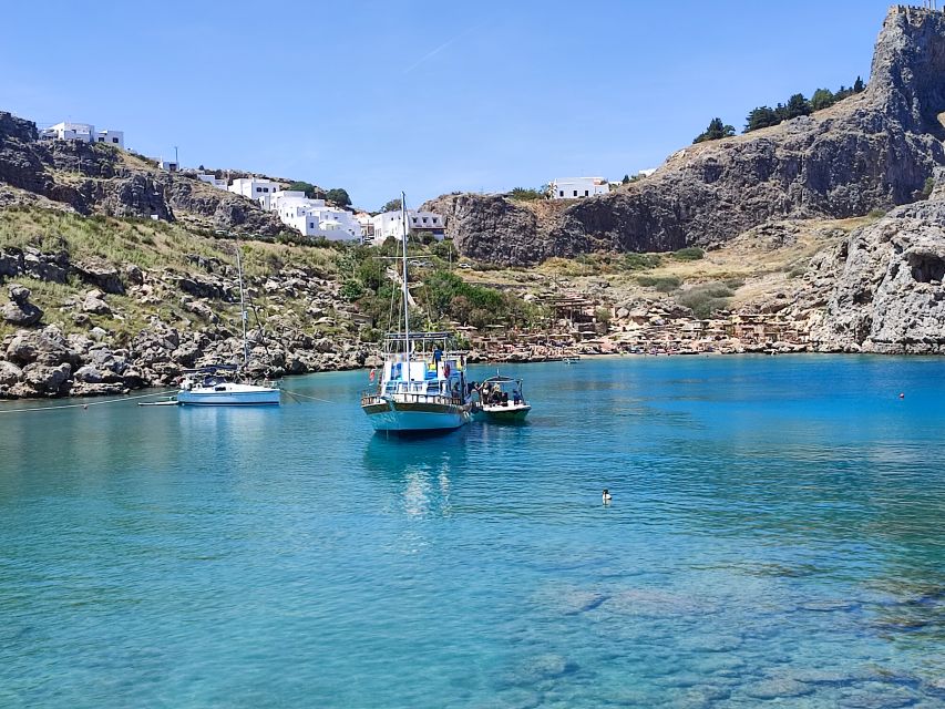 Lindos: Rhodes South-East Coast Cruise with Swim Stops - Calypso boat comfort: shade, seating, and a small-group feel