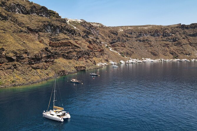 Luxury Santorini Sunset Cruise: Dinner, BBQ, Open Bar, Transfers - Sailing past Red Beach, White Beach, Indian Rocks, and Akrotiri Lighthouse