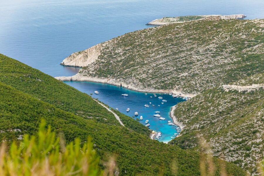 Porto Vromi: Shipwreck, Caves, & White Beach Swimming Cruise - The blue cave stretch: precise cruising and photo angles