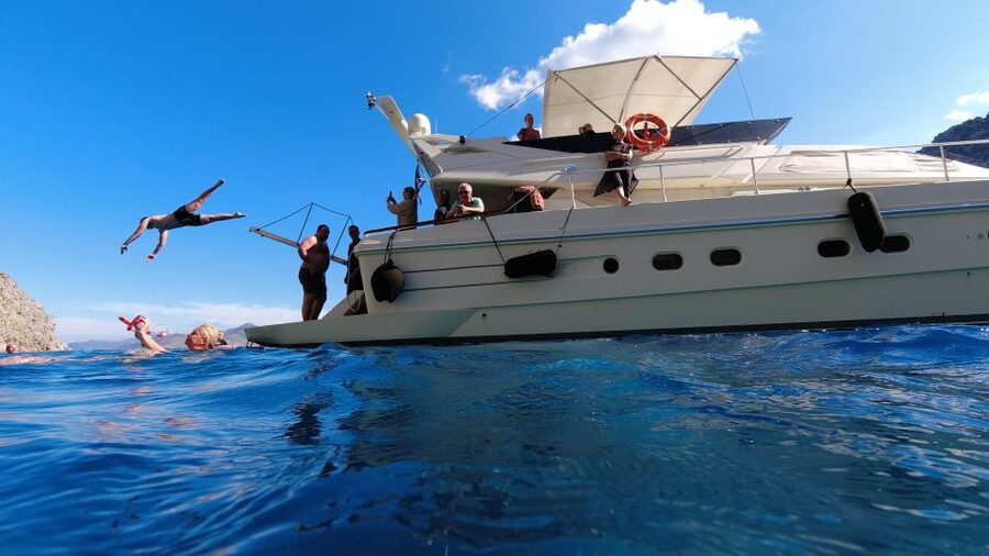 Rhodes: Symi Yacht Tour with Unlimited Drinks and Transfer - St. George Bay swim stop and lunch on board in the right order