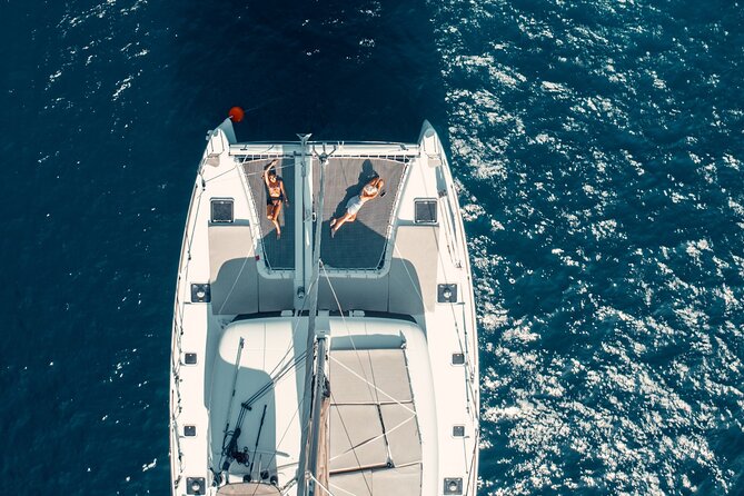 Romantic Sunset Catamaran Caldera Cruise incl. Meal & Drinks - Sunset in Oia from the water: the payoff moment