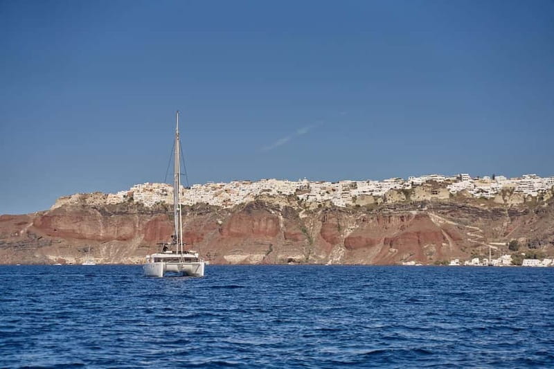 Santorini: Caldera Classic Catamaran Cruise w/ Meal & Drinks - Cruising past Akrotiri Lighthouse and the Indian Face Mountain