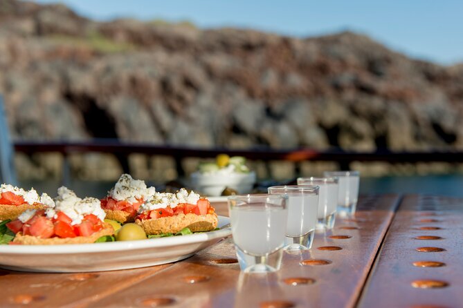 Santorini Caldera Sunset Traditional Cruise with Meal and Drinks - Akrotiri lighthouse, White Beach, and Red Beach stops