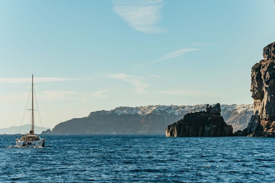 Santorini: Catamaran Caldera Cruise with Meal and Drinks - The hot springs near the volcano, plus volcanic beach vibes
