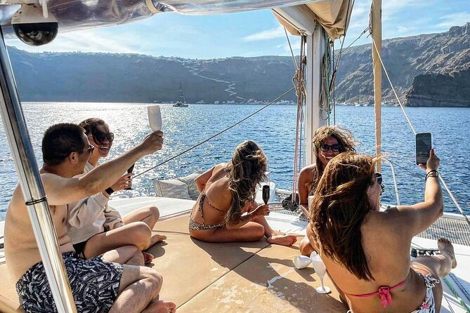 Santorini Catamaran Cruise: with Lunch, BBQ, Open Bar, Transfers - Sailing highlights: White Beach, Indian Rocks, and a Venetian Lighthouse sight