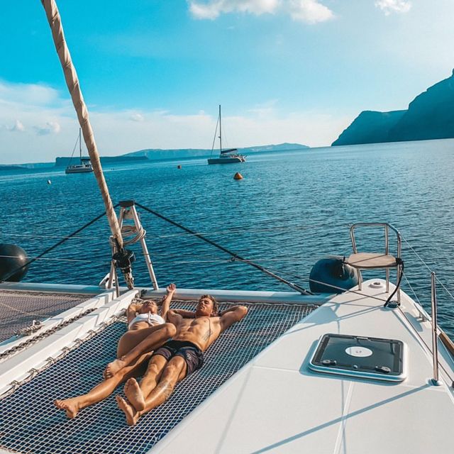 Santorini: Catamaran Cruise with Meal & Open Bar - First Swim Stop: Red Beach and the Volcanic Coast