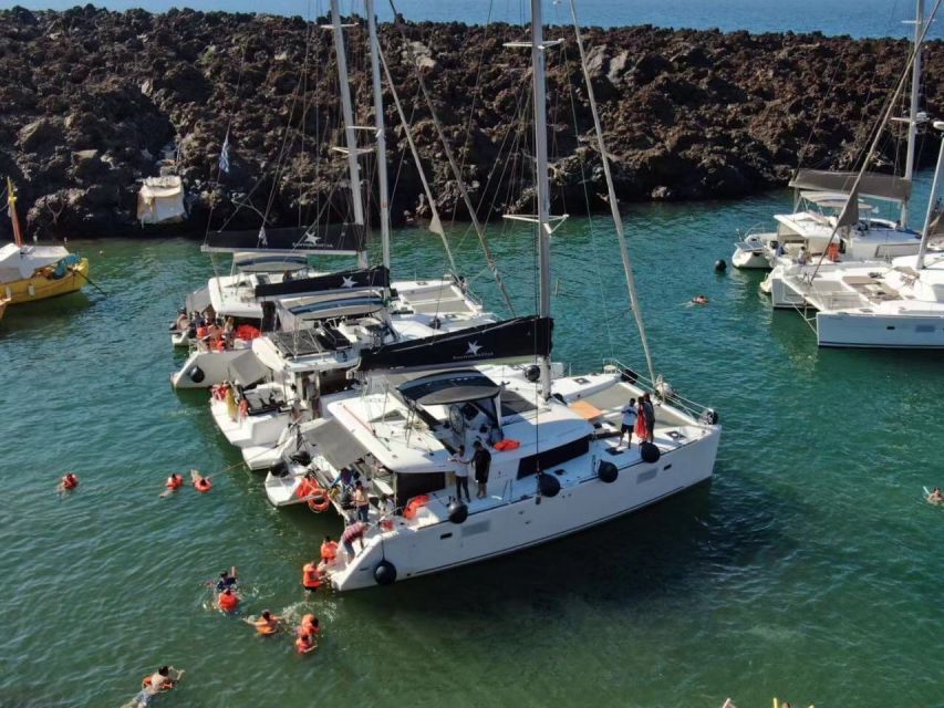 Santorini: Catamaran Cruise with Meal & Open Bar - Sailing by White Beach, Lighthouse Passes, and Photo Stops