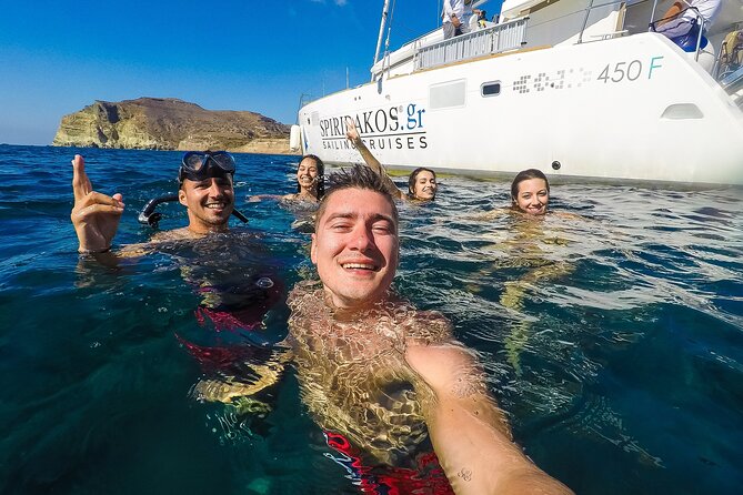 Santorini Classic Catamaran Cruise with BBQ, Drinks and Transfers - Mesa Pigadia swimming stop: your snorkel and sundeck window