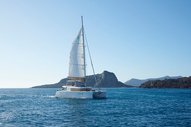 Santorini Gold Catamaran Cruise with BBQ, Drinks and Hotel Pickup - Venetian Lighthouse of Akrotiri: Photos, Sightseeing, and Quick Caldera Drama