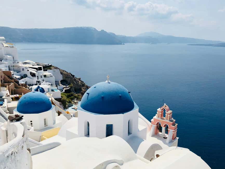 Santorini Guided Day Trip From Crete with Ferry Tickets - The volcano boat option: warm water, dramatic rocks, and extra cost