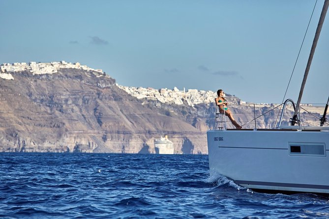 Santorini Luxury Sailing Catamaran Cruise with BBQ, Drinks and Transfer - White Beach stop: swimming near the cliffs and getting your Greek BBQ lunch
