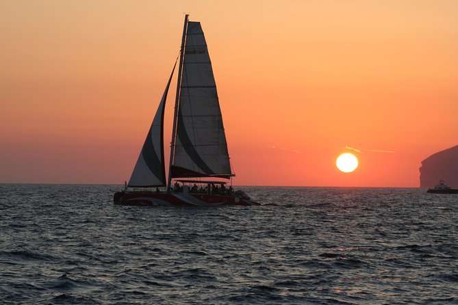 Santorini Sailing Dream Catcher with BBQ Lunch and Drinks - The catamaran setup, seating, and the small-group reality