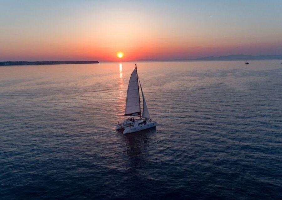 Santorini: Sunset Cruise with Swim Stops, Dinner, and Drinks - Red Beach Swimming and the Colored-Coastline Effect